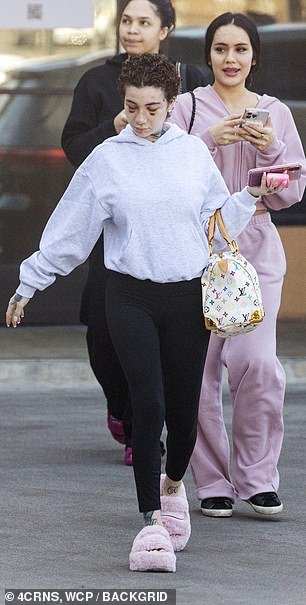 She toted a white, leather duffel bag with a colorful Louis Vuitton monogram and gold hardware for her outing