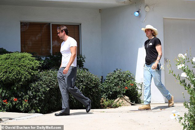 Luke followed behind Christian as they walked across the driveway to the other end of the property where a black Ford Bronco was parked