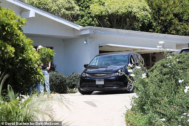 A black Chrysler vehicle, seemingly belonging to the coroner, was also parked in Madsen's driveway
