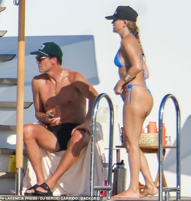 Johnson received a hug from Hudson, who stood directly behind her as the pair soaked up the summer sun, while the retired NFL quarterback lounged nearby