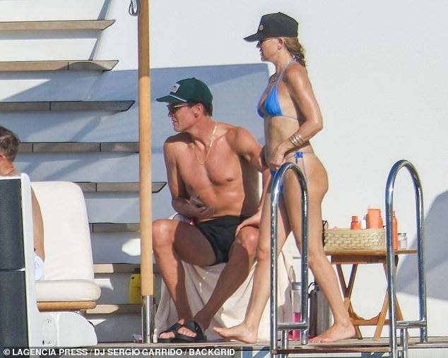 The sports star showed off her sculpted physique as he went shirtless under the bright sun and sported a pair of black swim trunks