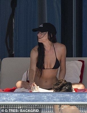 Later in the day, Johnson was seen spending time in the shade as she relaxed on a lounge chair in a covered area of the yacht
