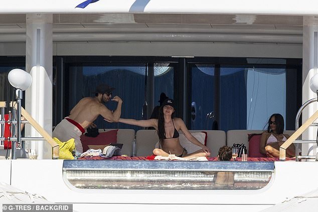 Johnson held a small grin as she lightly touched the mystery man's bicep on the boat