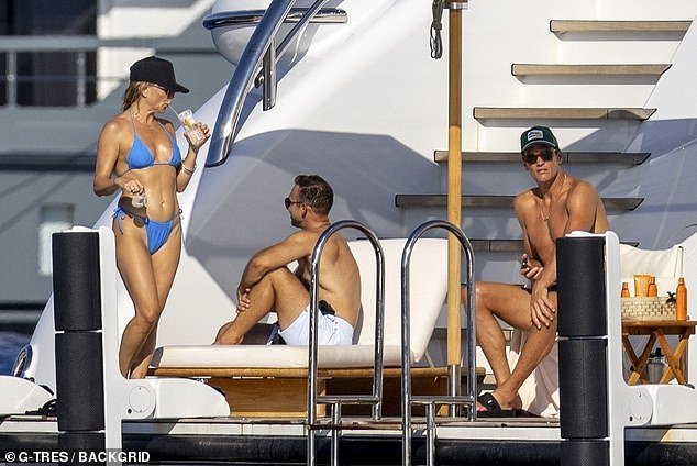 He was seen sitting in a chair on an open area of the yacht and mingled with both Hudson and Johnson