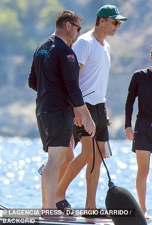 He opted to wear a plain white T-shirt along with the swim trunks