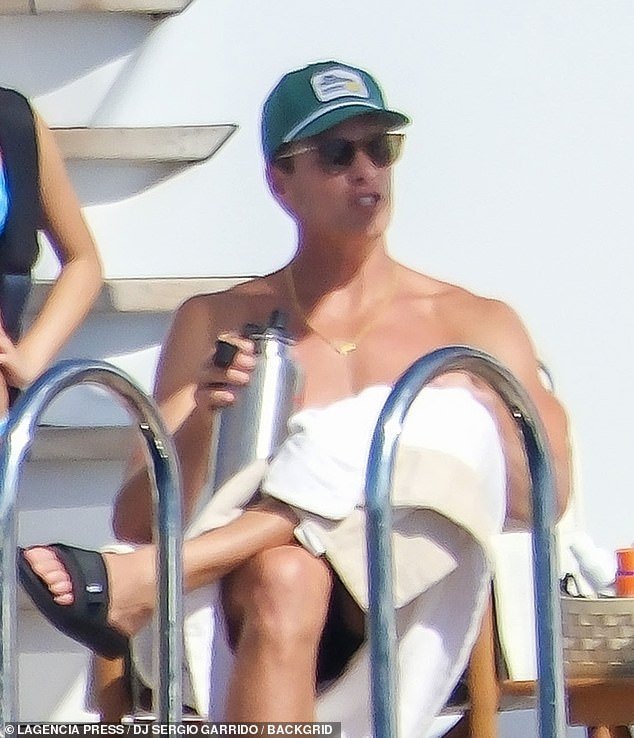 Tom stayed hydrated in the warmer temperatures by sipping from a large silver water bottle